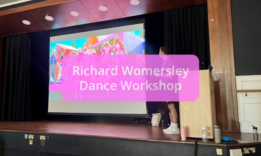 Image shows Richard Womersley on stage talking pupils through a scene from the Barbie movie, with the words Richard Womersley Dance Workshop